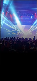 Stage lighting over a seated brand-event audience